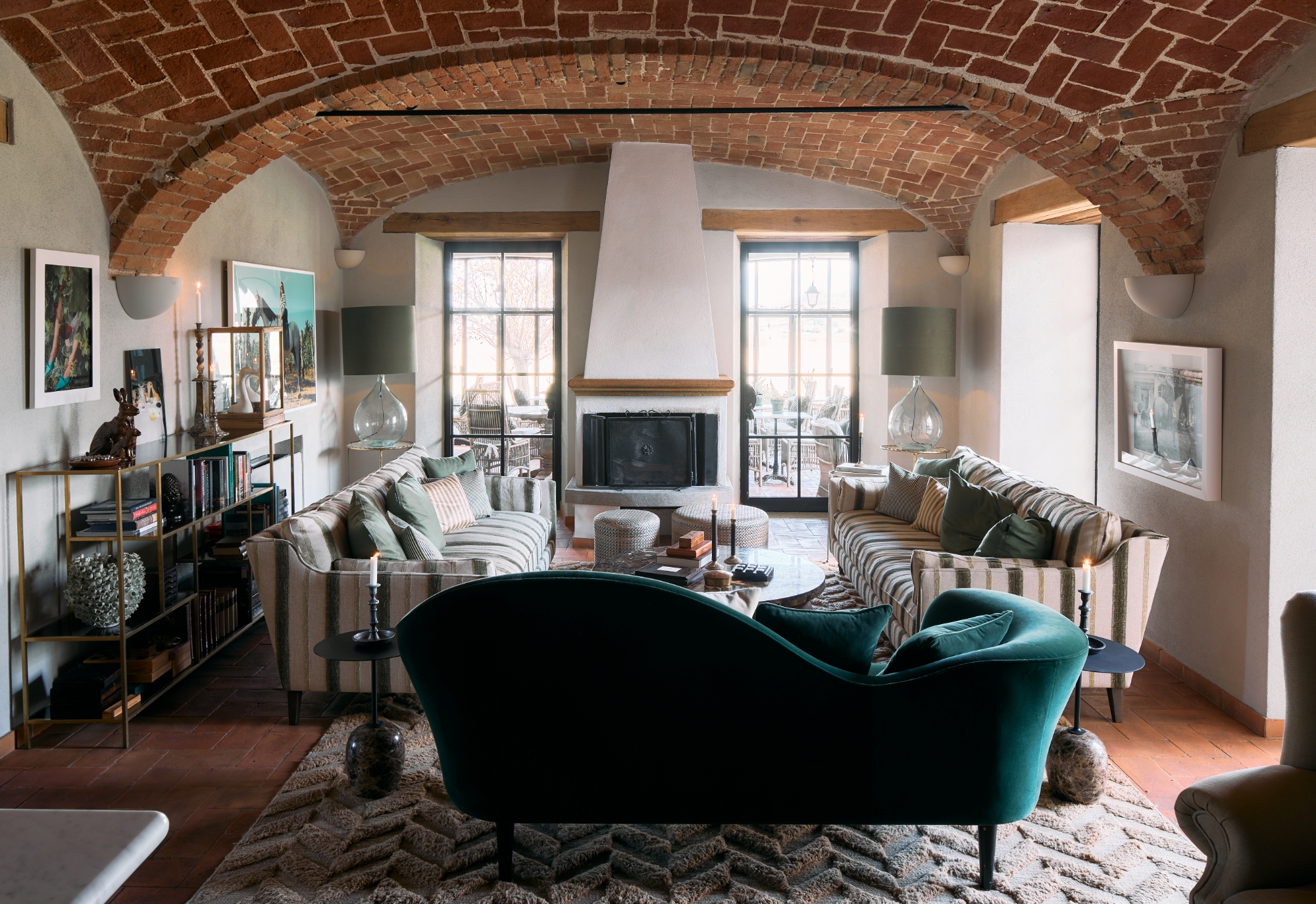 our-hotel_open-area Big room with tree sofas and a fireplace