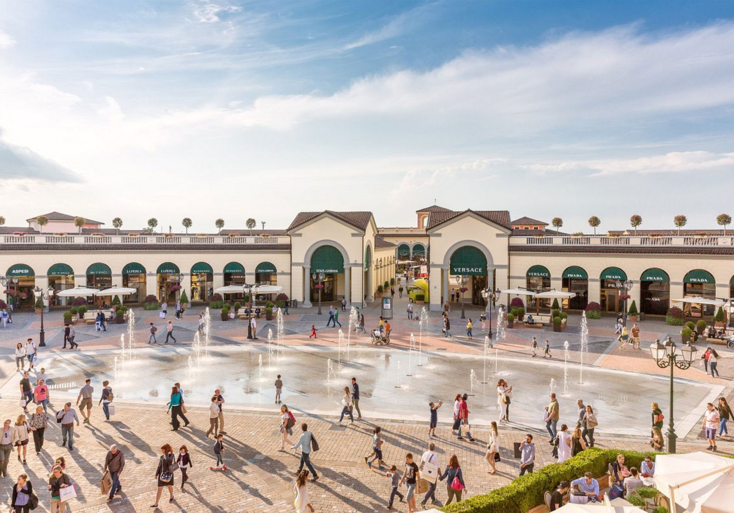 activities_excursions_serravalle_designer-outlet A square with shops and people