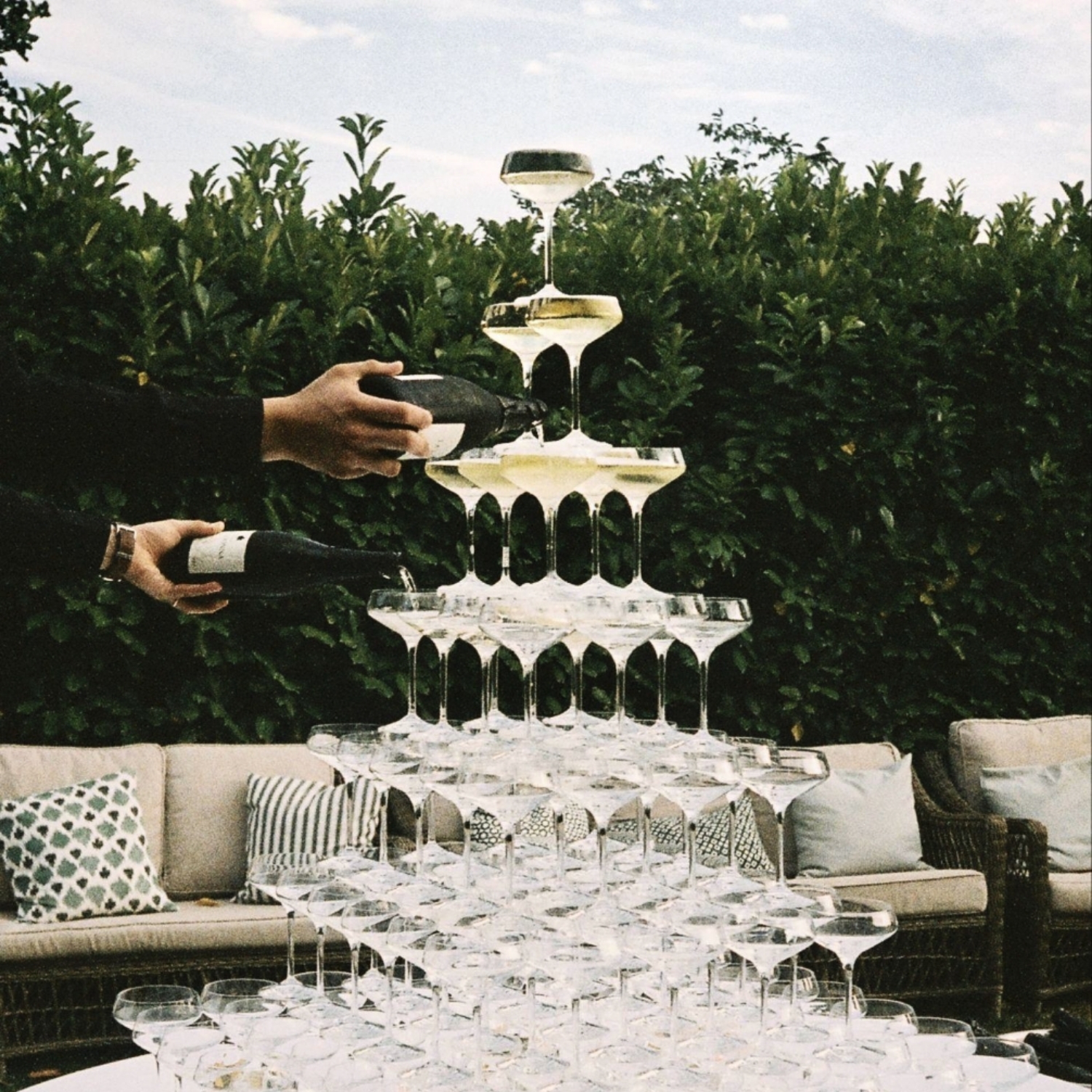 Pouring up drinks in glasses in a pyramid