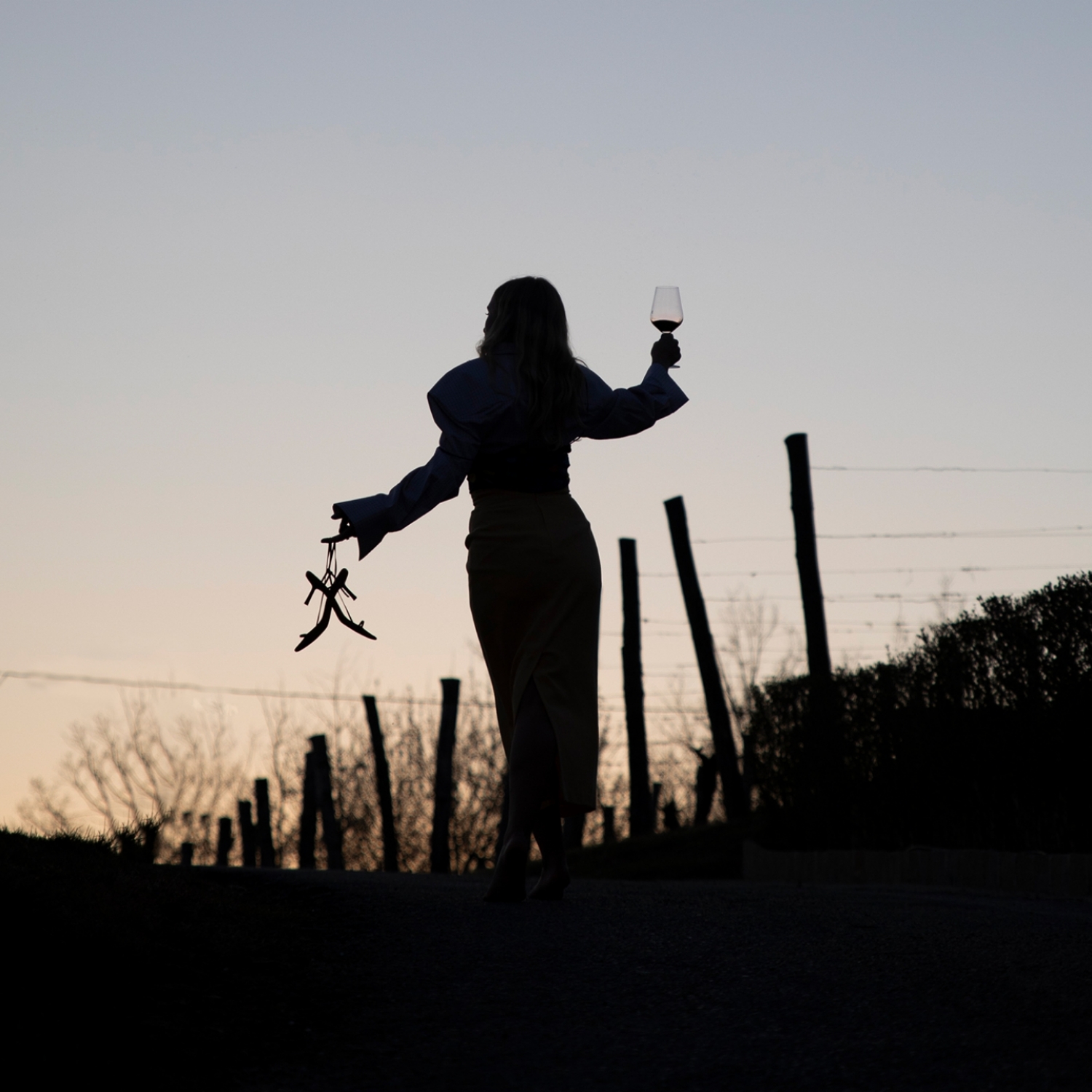 Woman with heels and glass in her hands